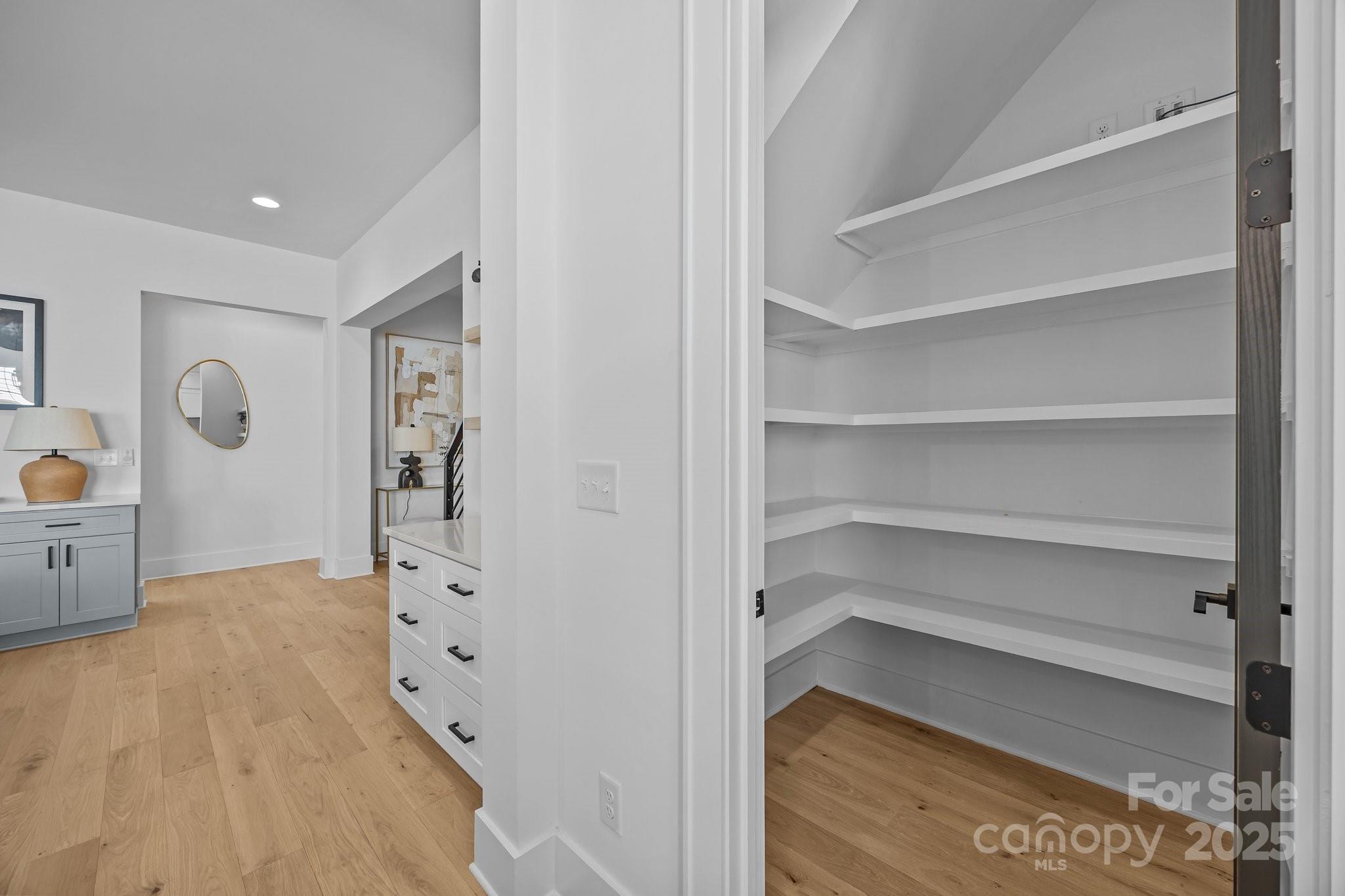 3949 Plainview Road Charlotte, NC 28208 - Photo 32 of 42 a view of walk in closet with empty racks
