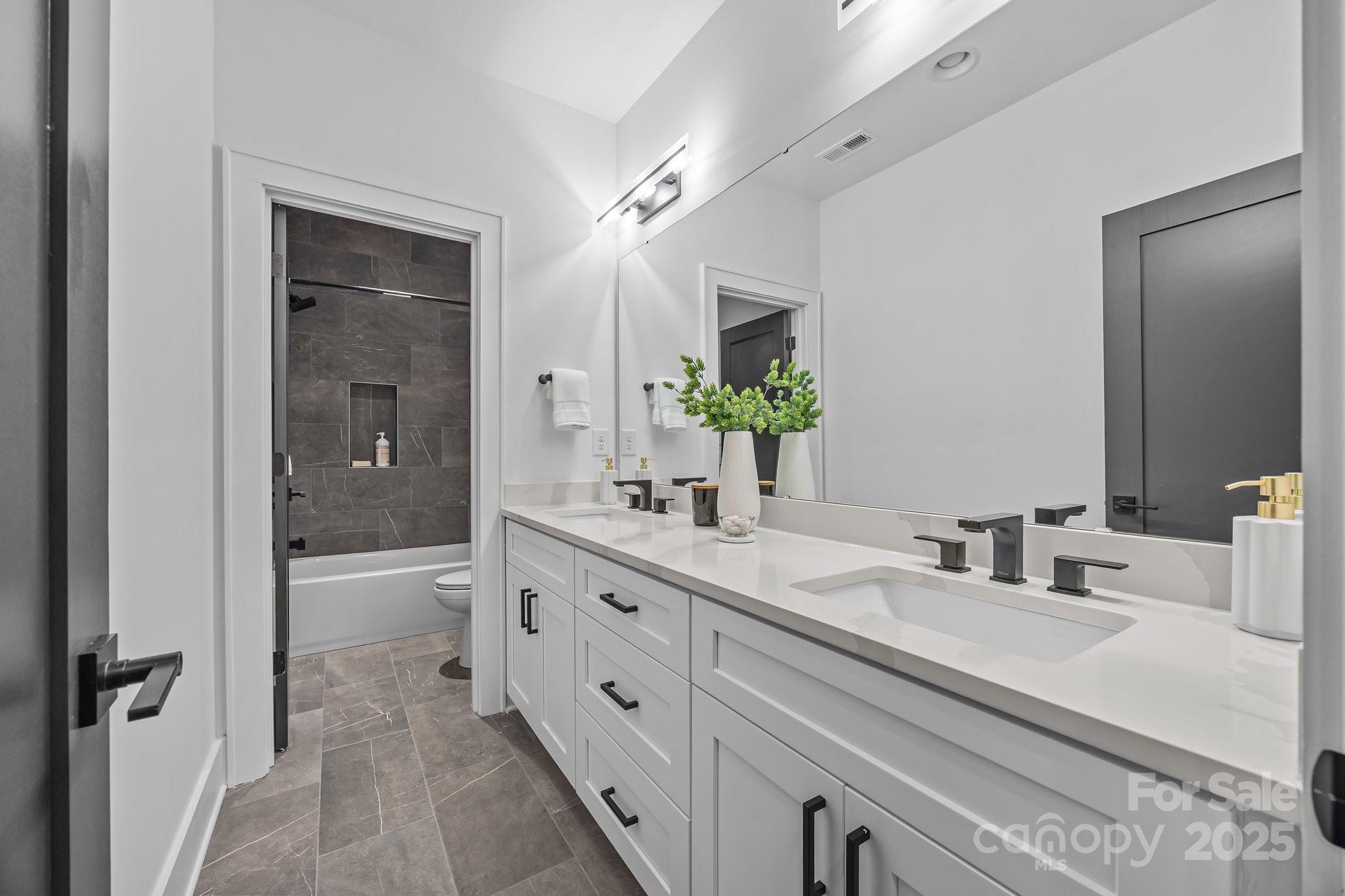 3949 Plainview Road Charlotte, NC 28208 - Photo 41 of 42 a bathroom with a double vanity sink and mirror