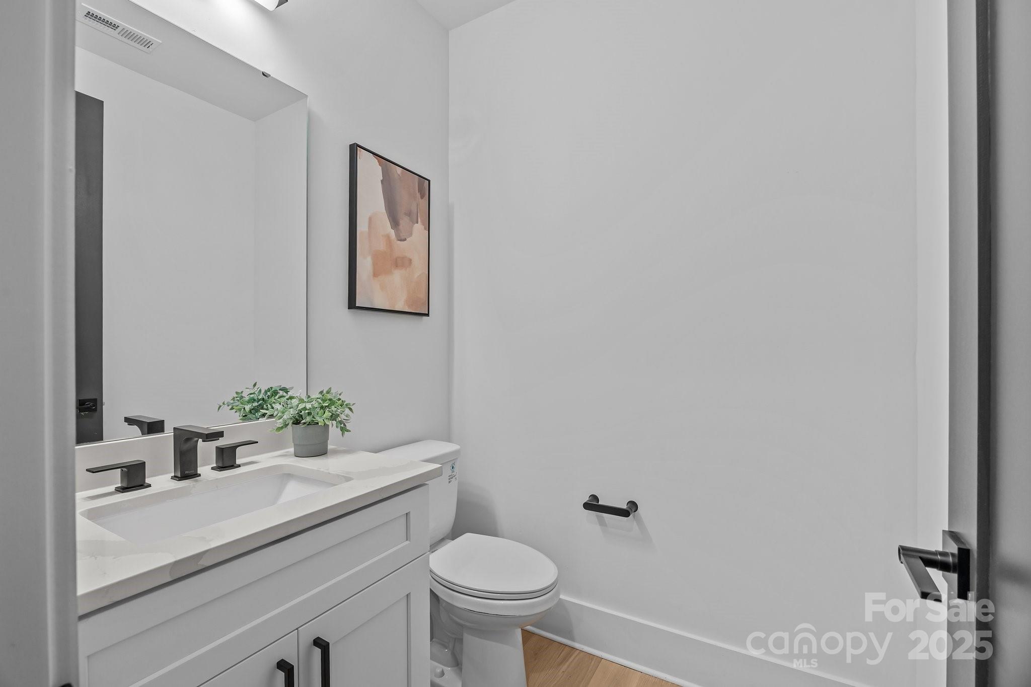 3949 Plainview Road Charlotte, NC 28208 - Photo 9 of 42 a bathroom with a sink a toilet and a mirror
