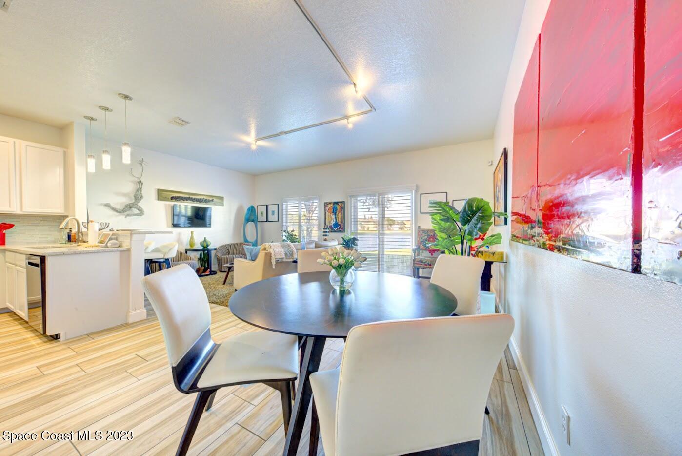 2760 Revolution Street, Unit 103 Melbourne, FL 32935 - Photo 11 of 40 a view of a dining room with furniture and a potted plant
