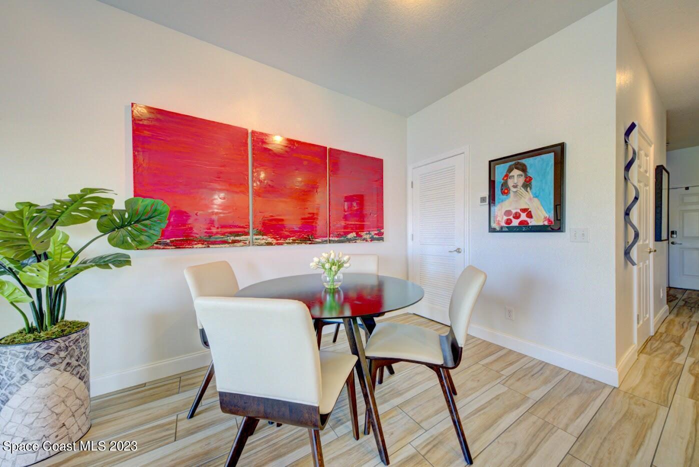 2760 Revolution Street, Unit 103 Melbourne, FL 32935 - Photo 12 of 40 a view of a dining room with furniture window and wooden floor