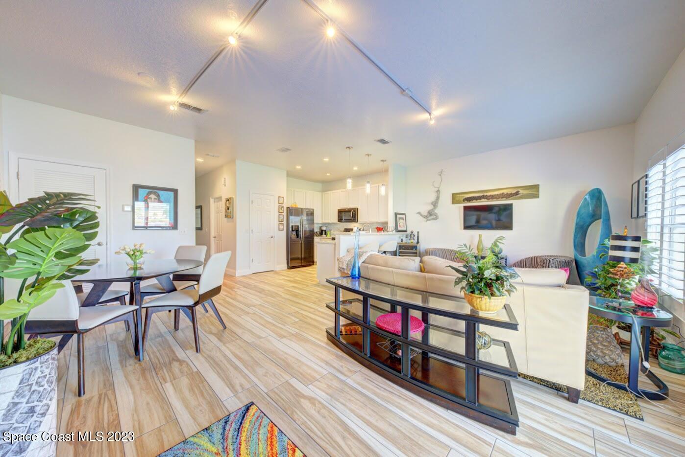 2760 Revolution Street, Unit 103 Melbourne, FL 32935 - Photo 13 of 40 a living room with furniture and a wooden floor