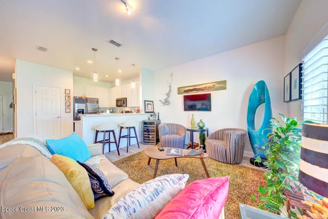 a living room with furniture kitchen view and a table