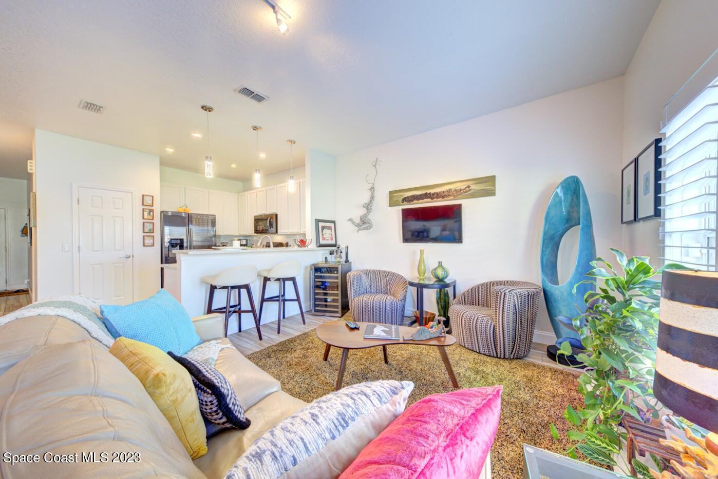 2760 Revolution Street, Unit 103 Melbourne, FL 32935 - Photo 14 of 40 a living room with furniture and a potted plant
