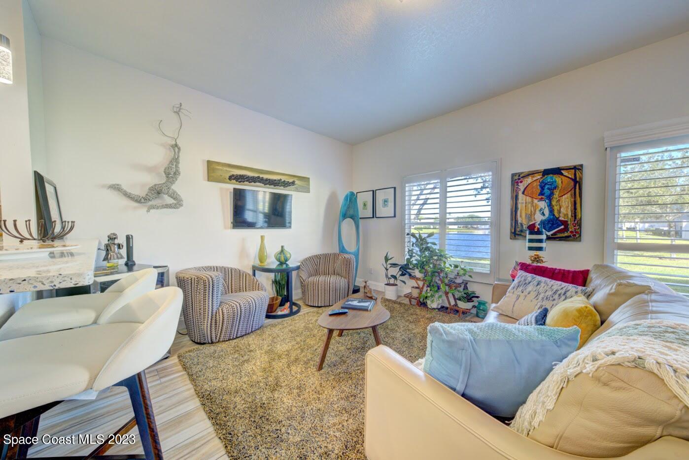 2760 Revolution Street, Unit 103 Melbourne, FL 32935 - Photo 15 of 40 a living room with furniture and a flat screen tv