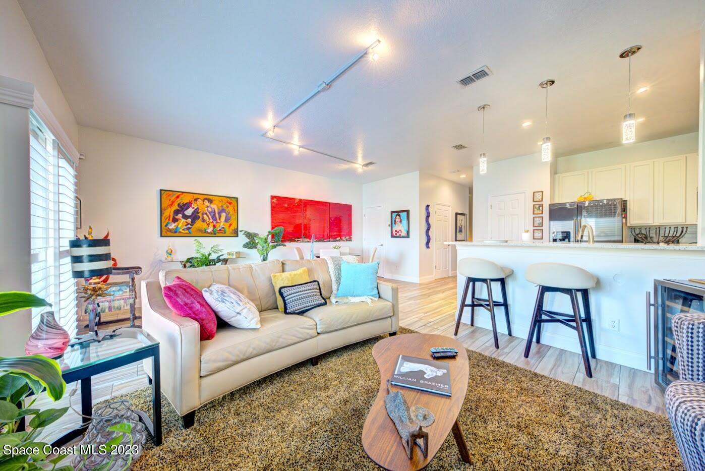 2760 Revolution Street, Unit 103 Melbourne, FL 32935 - Photo 17 of 40 a living room with furniture kitchen view and a table