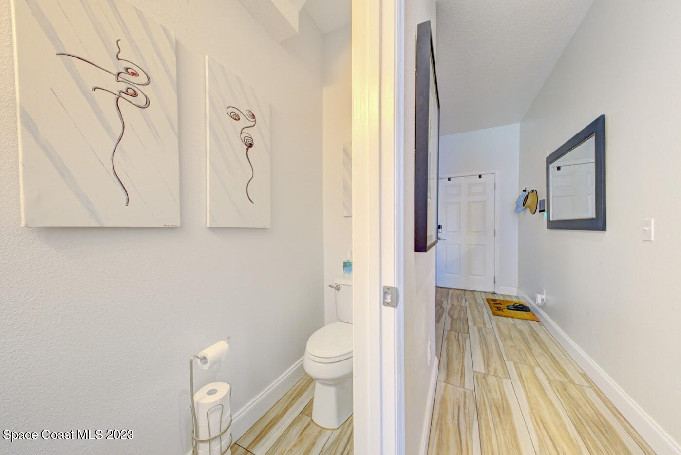 2760 Revolution Street, Unit 103 Melbourne, FL 32935 - Photo 19 of 40 a bathroom with a sink a toilet and shower