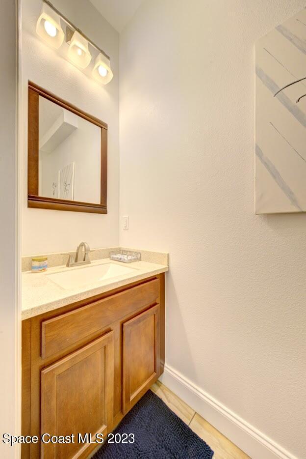 2760 Revolution Street, Unit 103 Melbourne, FL 32935 - Photo 20 of 40 a bathroom with a sink and a mirror