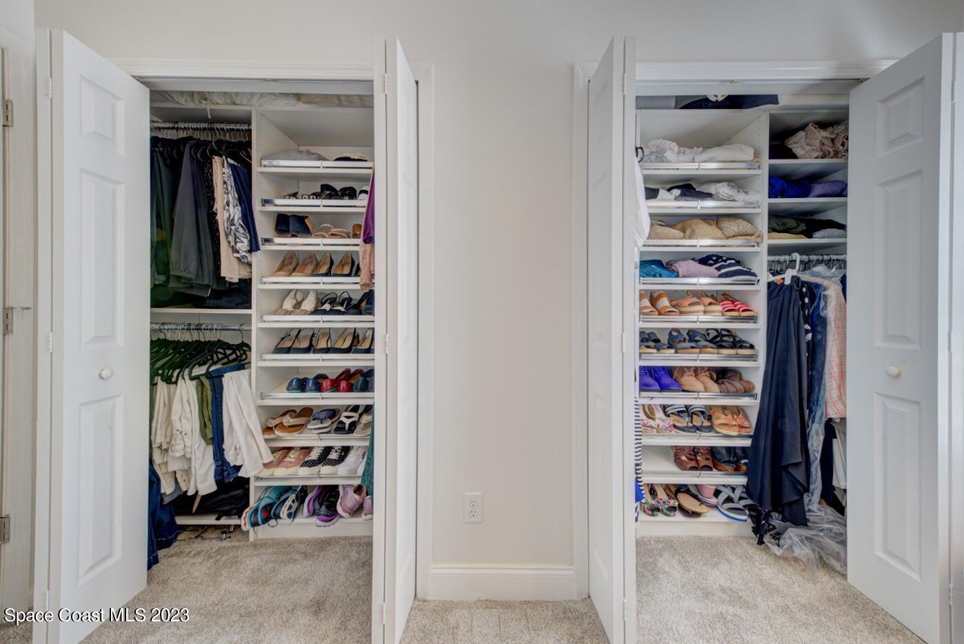 2760 Revolution Street, Unit 103 Melbourne, FL 32935 - Photo 25 of 40 a view of walk in closet with clothes and shoes