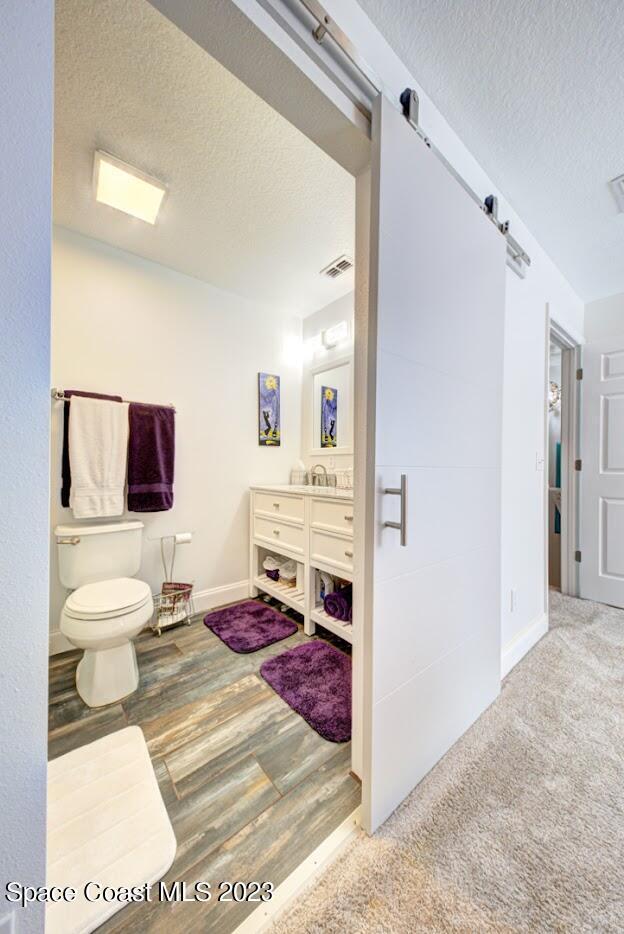 2760 Revolution Street, Unit 103 Melbourne, FL 32935 - Photo 26 of 40 a bathroom with a toilet sink and mirror