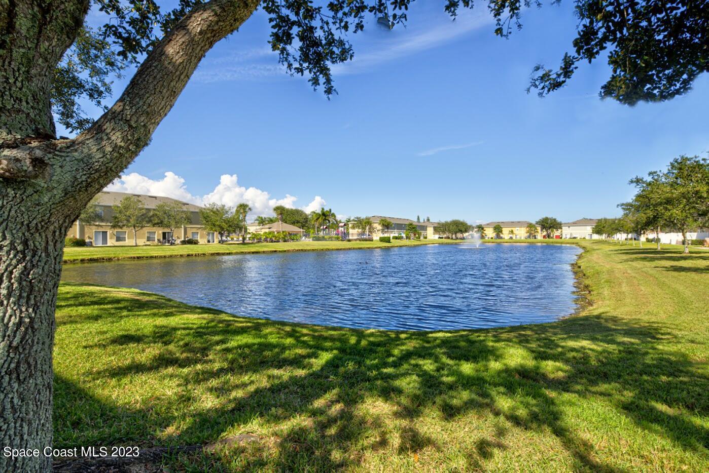 2760 Revolution Street, Unit 103 Melbourne, FL 32935 - Photo 35 of 40 a view of a lake with houses in the back