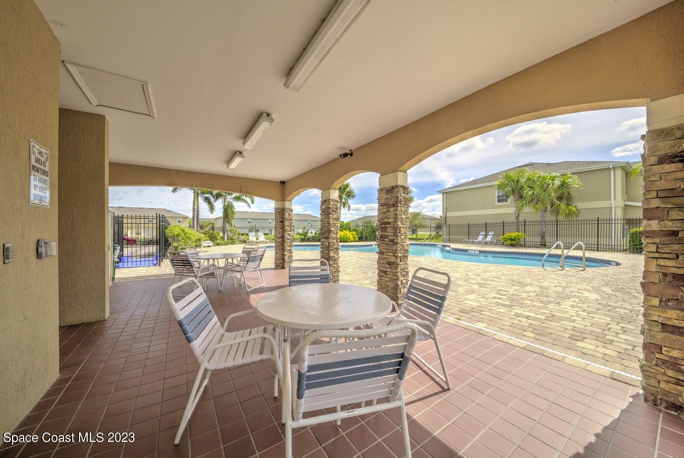 2760 Revolution Street, Unit 103 Melbourne, FL 32935 - Photo 37 of 40 a dining room with furniture and a floor to ceiling window