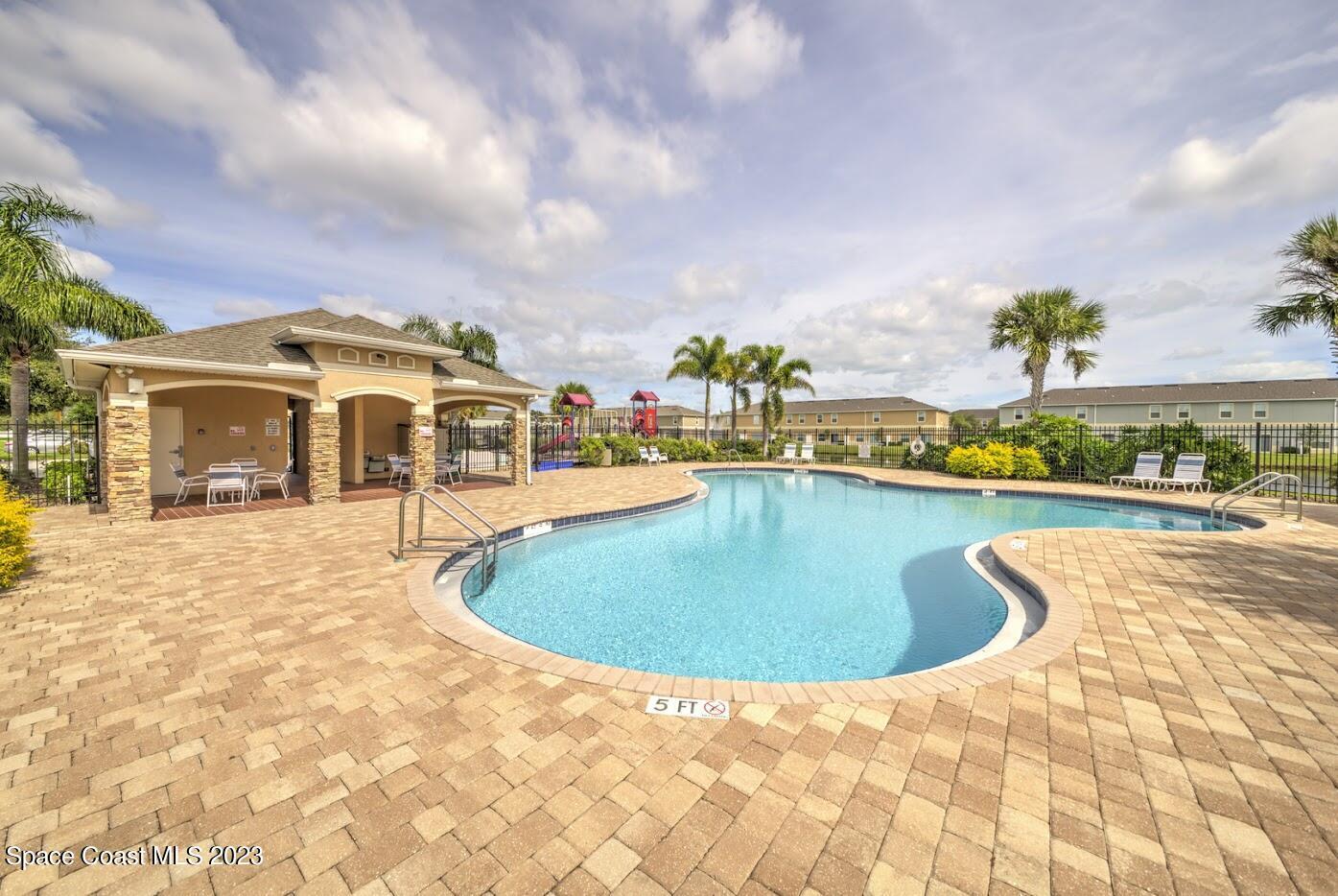 2760 Revolution Street, Unit 103 Melbourne, FL 32935 - Photo 38 of 40 a swimming pool with outdoor seating and barbeque oven