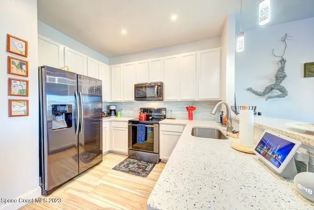 a living room with furniture a rug and a floor to ceiling window