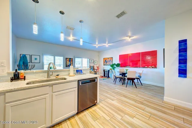 a view of a dining room with furniture and a potted plant