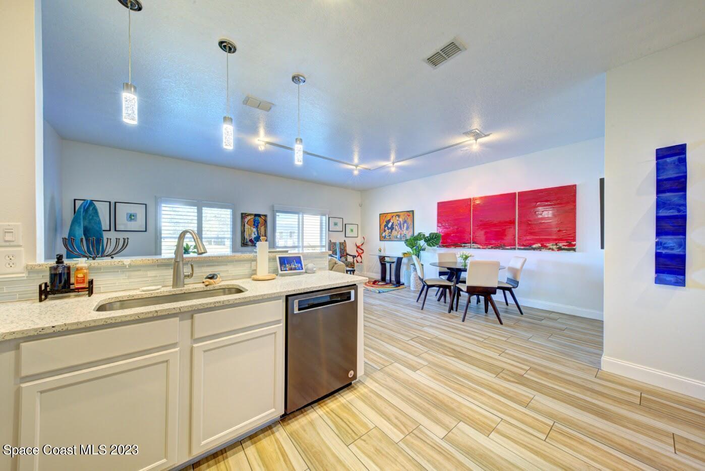 2760 Revolution Street, Unit 103 Melbourne, FL 32935 - Photo 8 of 40 a kitchen with a sink cabinets and wooden floor