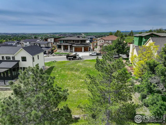 an aerial view of multiple houses with a yard