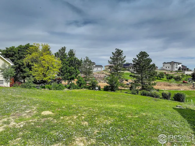 a backyard of a house with lots of green space and outdoor seating