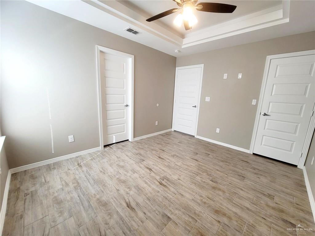 1420 Alta Vista Drive, Unit 4 Weslaco, TX 78596 - Photo 7 of 14 an empty room with wooden floor