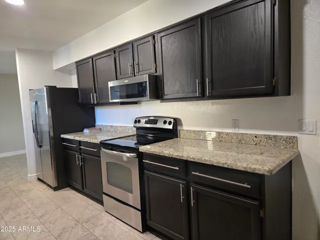 a kitchen with granite countertop cabinets sink and a granite counter top
