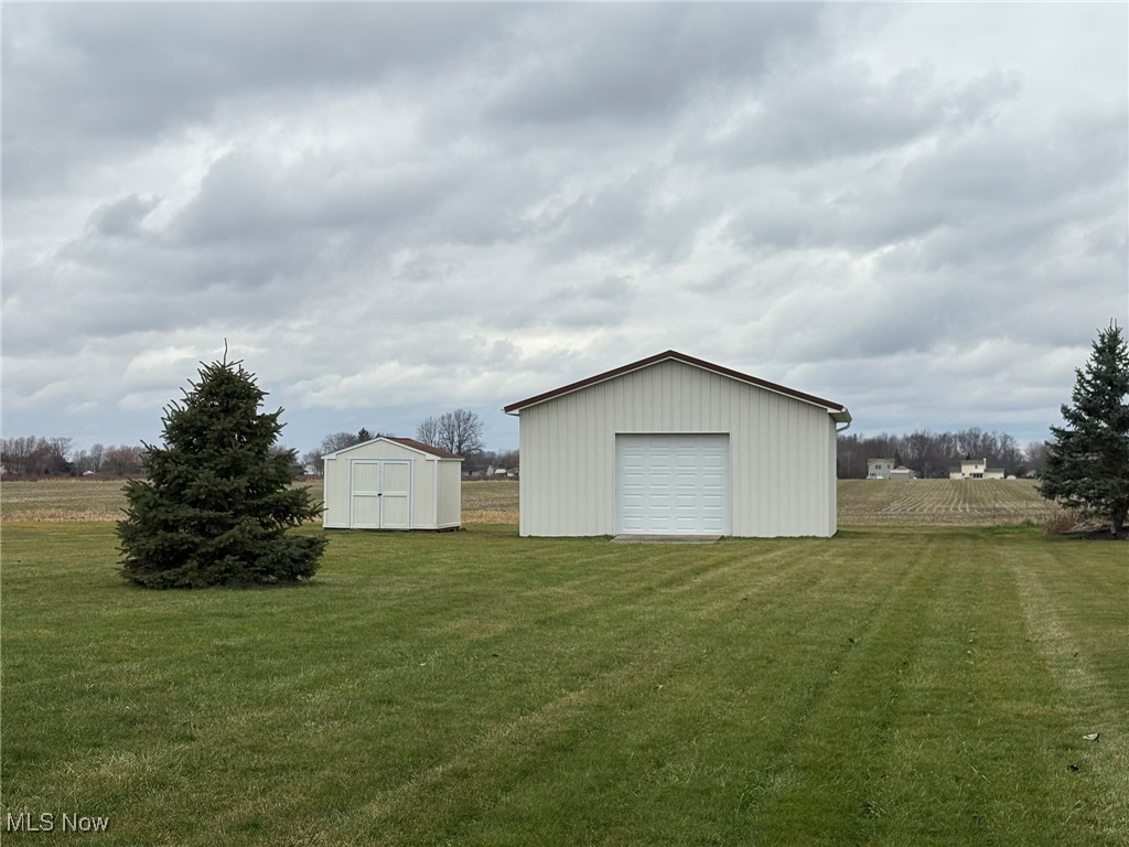 9260 Fowl Road Elyria, OH 44035 - Photo 22 of 25 View of yard with a rural view, an outdoor structure, and a garage
