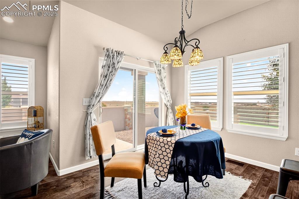 4293 Hessite Loop Colorado Springs, CO 80938 - Photo 15 of 37 a view of a dining room with furniture window and outside view