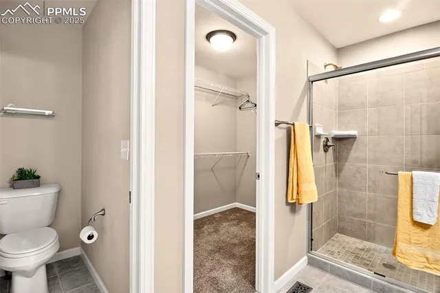 a bathroom with a granite countertop shower a toilet and a sink