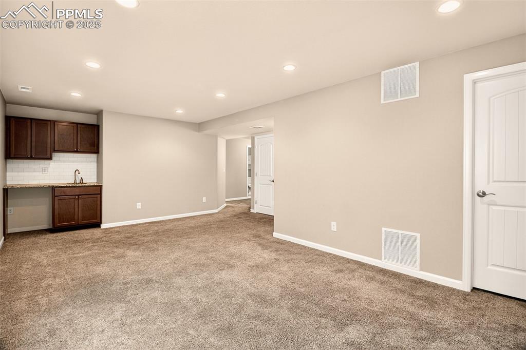 4293 Hessite Loop Colorado Springs, CO 80938 - Photo 24 of 37 a view of an empty room with kitchen