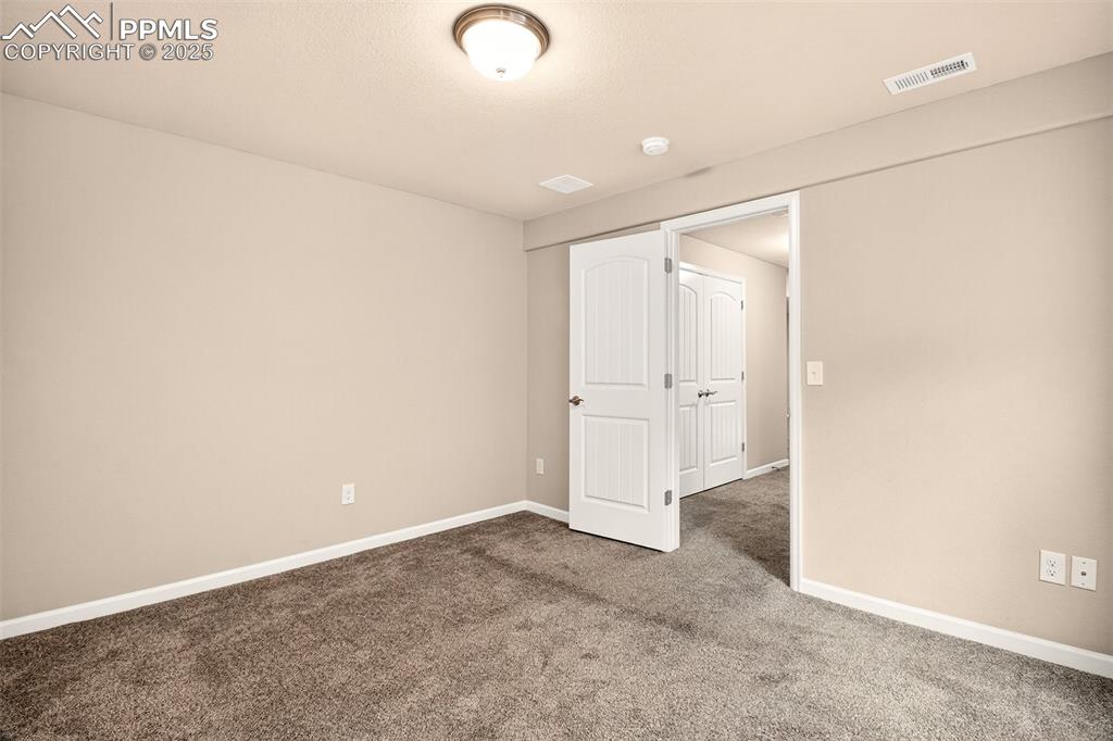 4293 Hessite Loop Colorado Springs, CO 80938 - Photo 29 of 37 an empty room with an entryway