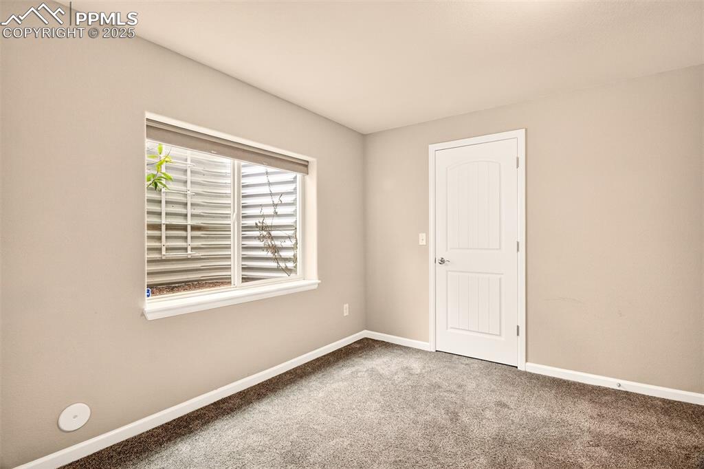 4293 Hessite Loop Colorado Springs, CO 80938 - Photo 30 of 37 a view of an empty room with a window