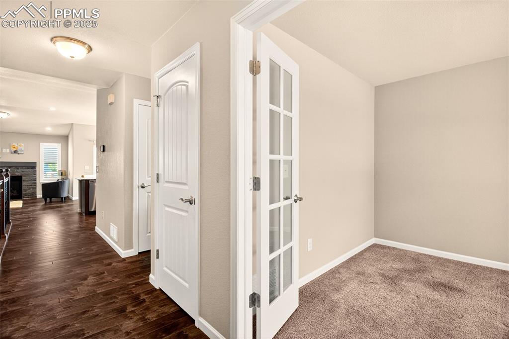 4293 Hessite Loop Colorado Springs, CO 80938 - Photo 6 of 37 a view of a hallway with wooden floor