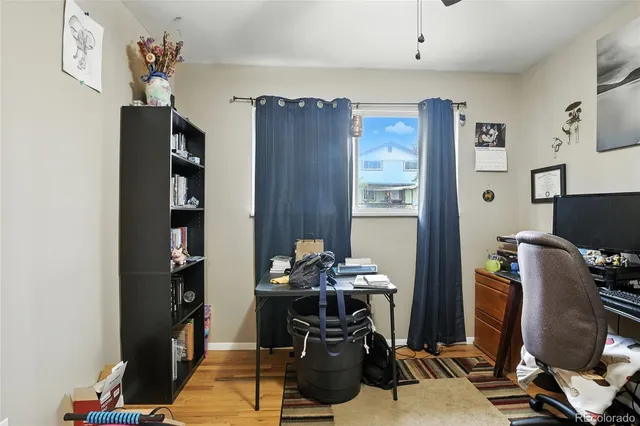 a view of a workspace with furniture and gym equipment