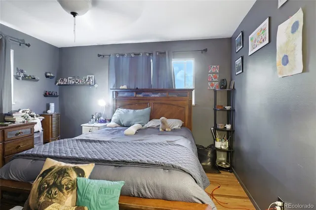 a bed sitting in a bedroom next to a window