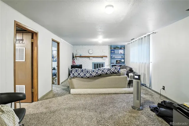 a living room with a bed furniture and a window