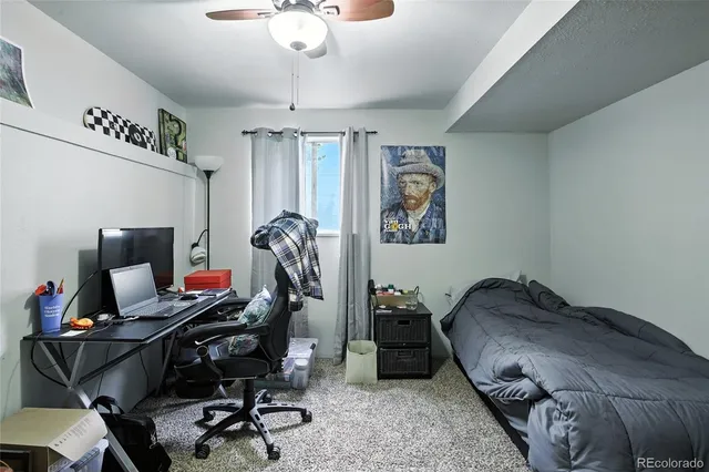 a bedroom with a workspace
