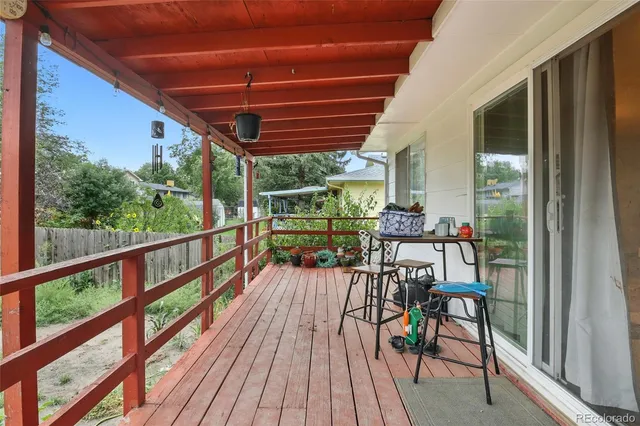 a view of a chairs and table in patio with wooden floor