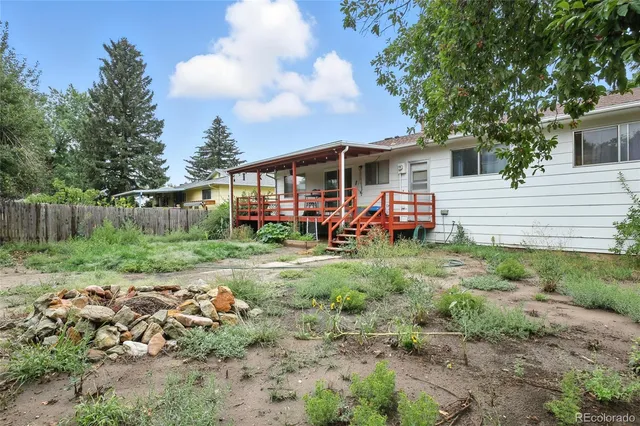 a view of a yard with a house in the background