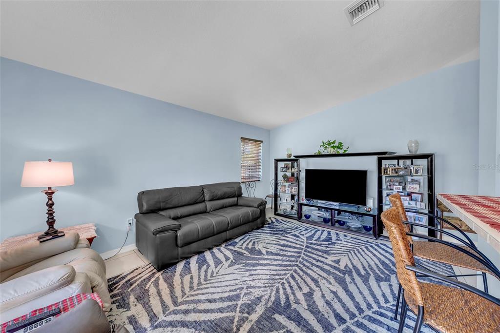 21131 Southwest 128th Court Miami, FL 33177 - Photo 11 of 24 a bedroom with furniture a flat screen tv and a fireplace