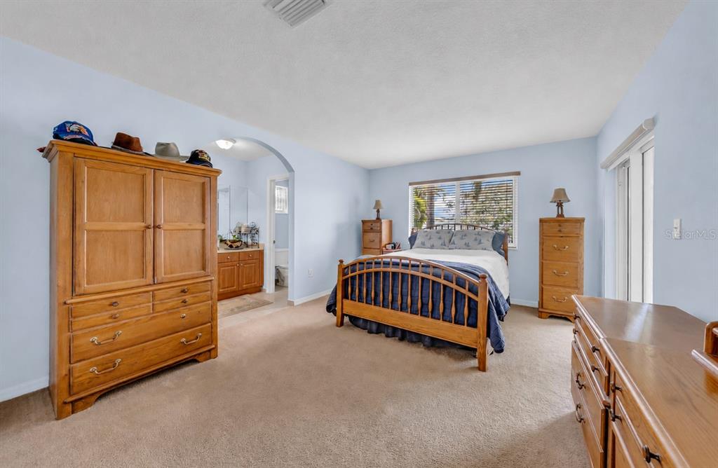 21131 Southwest 128th Court Miami, FL 33177 - Photo 13 of 24 a bedroom with a bed and a dresser