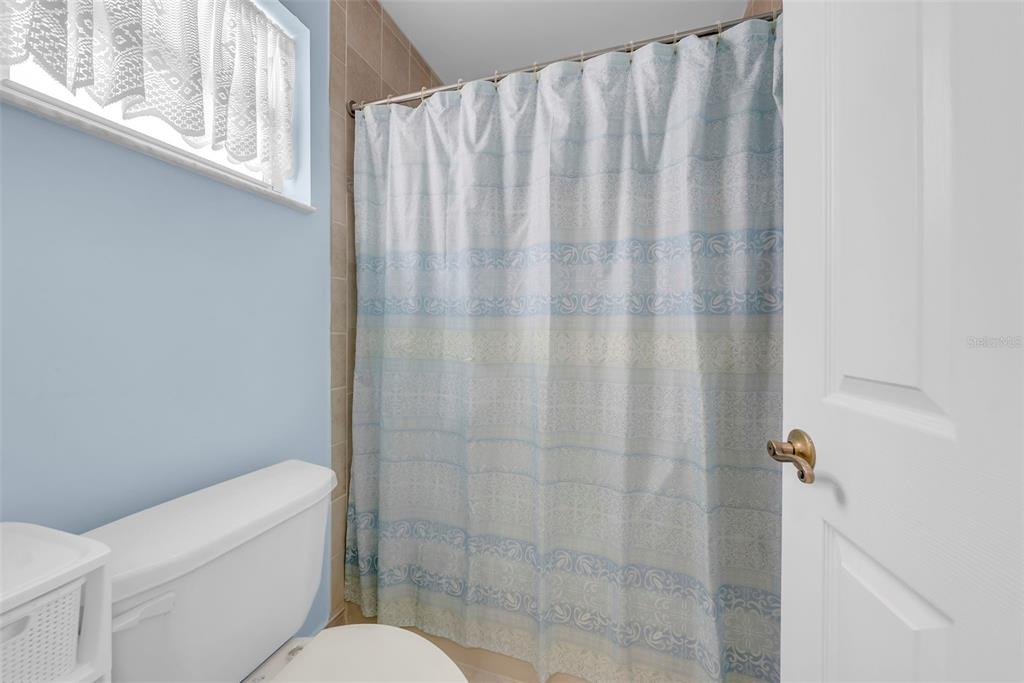 21131 Southwest 128th Court Miami, FL 33177 - Photo 16 of 24 a white toilet sitting next to a shower
