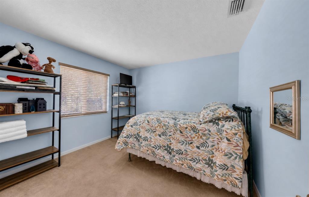 21131 Southwest 128th Court Miami, FL 33177 - Photo 17 of 24 a bedroom with bed and a window