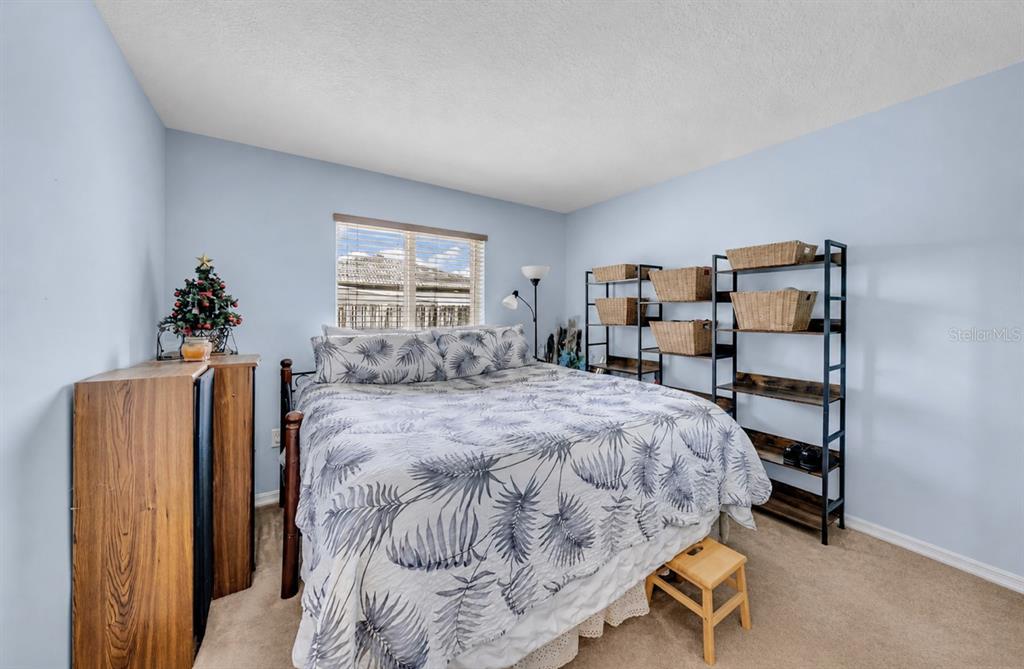 21131 Southwest 128th Court Miami, FL 33177 - Photo 19 of 24 a bedroom with a bed and wooden floor
