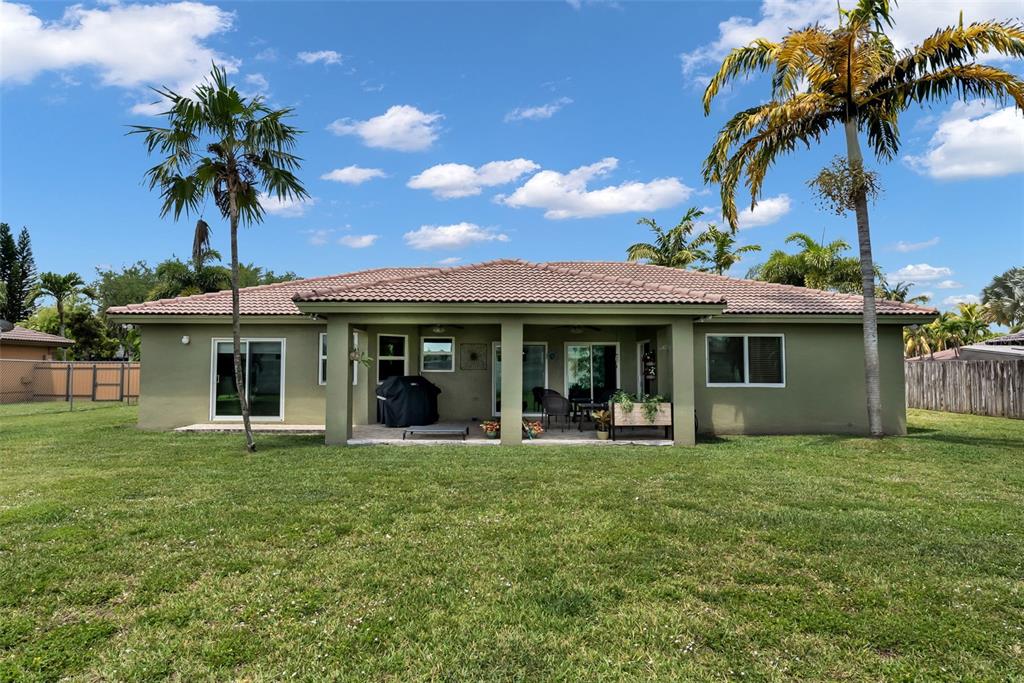 21131 Southwest 128th Court Miami, FL 33177 - Photo 20 of 24 a front view of a house with garden