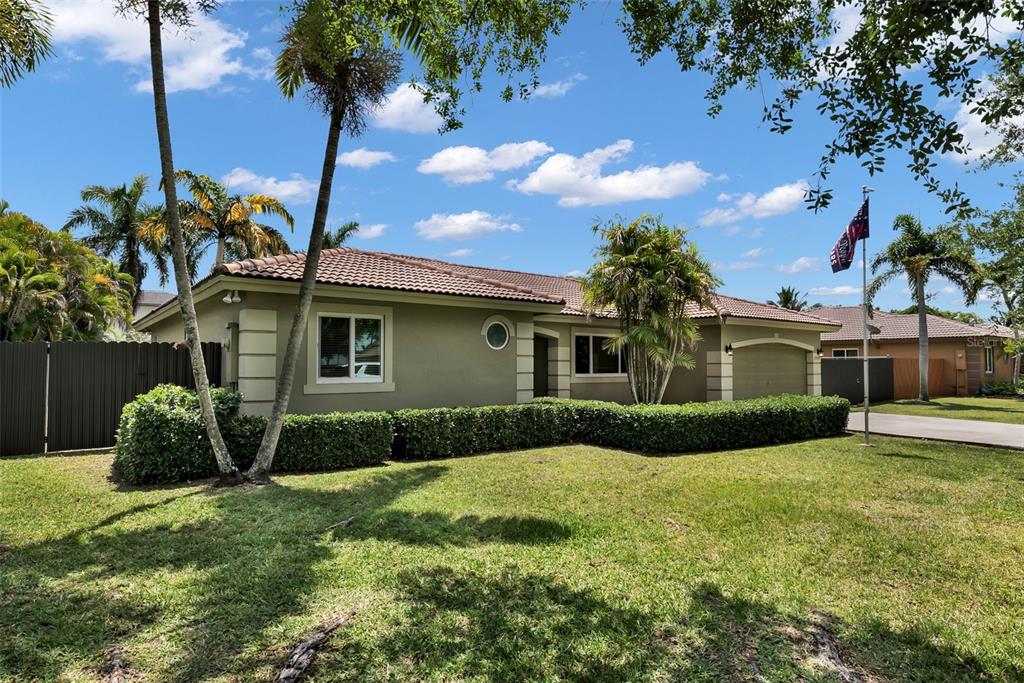 21131 Southwest 128th Court Miami, FL 33177 - Photo 2 of 24 a front view of a house with garden