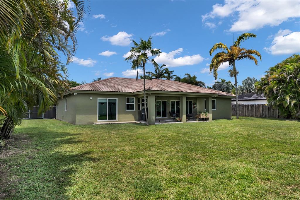 21131 Southwest 128th Court Miami, FL 33177 - Photo 21 of 24 a front view of a house with a garden