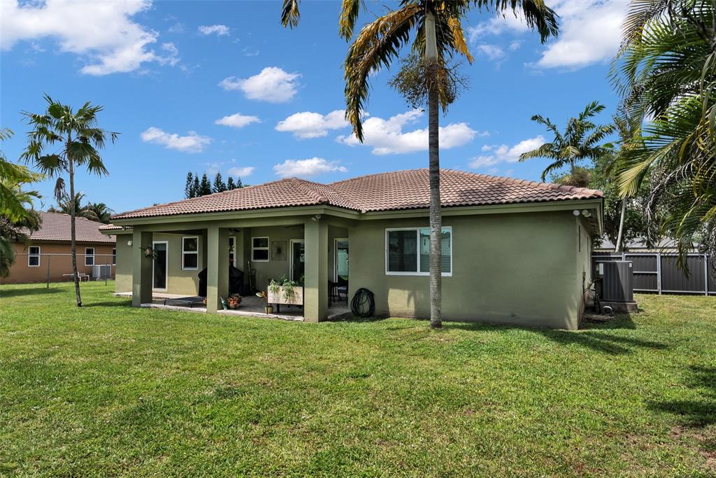 21131 Southwest 128th Court Miami, FL 33177 - Photo 22 of 24 a front view of a house with garden