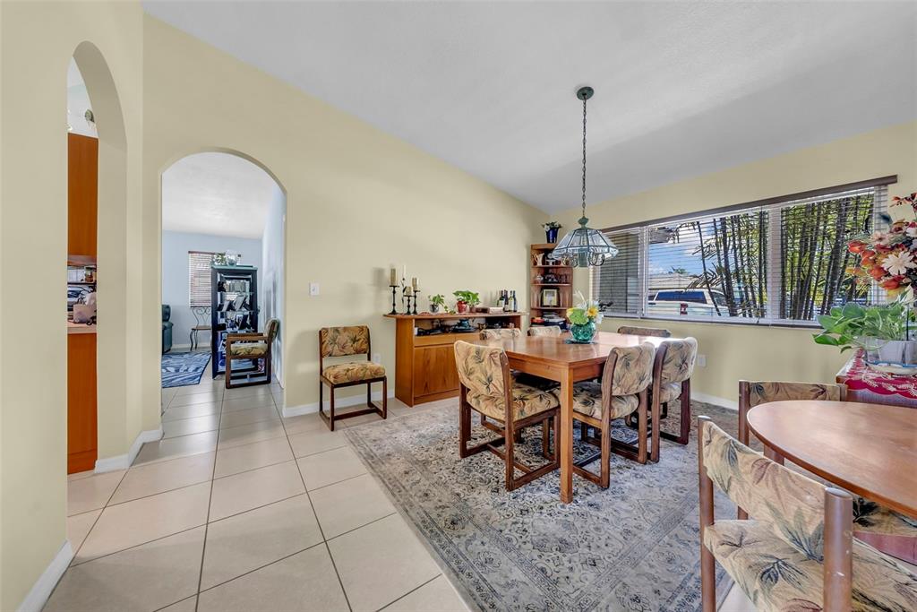 21131 Southwest 128th Court Miami, FL 33177 - Photo 6 of 24 a view of a dining room and livingroom with furniture window and a chandelier