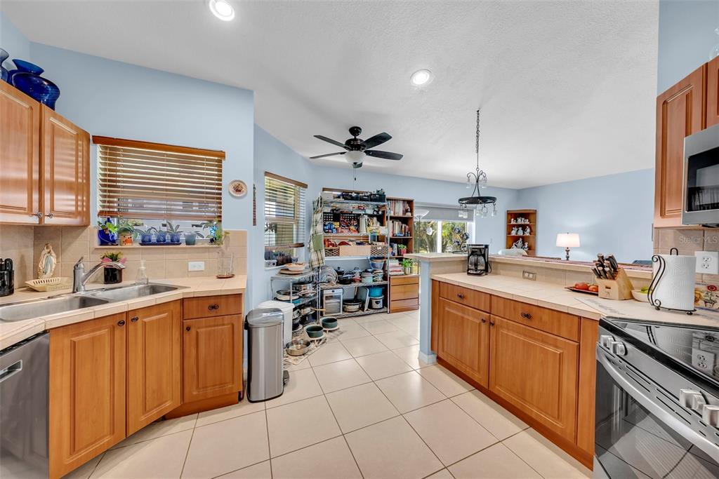 21131 Southwest 128th Court Miami, FL 33177 - Photo 8 of 24 a kitchen with a sink window and cabinets