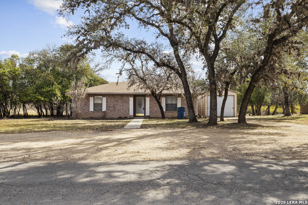 292 Montague Drive Bandera, TX 78003 - Photo 1 of 24 a front view of a house with a yard