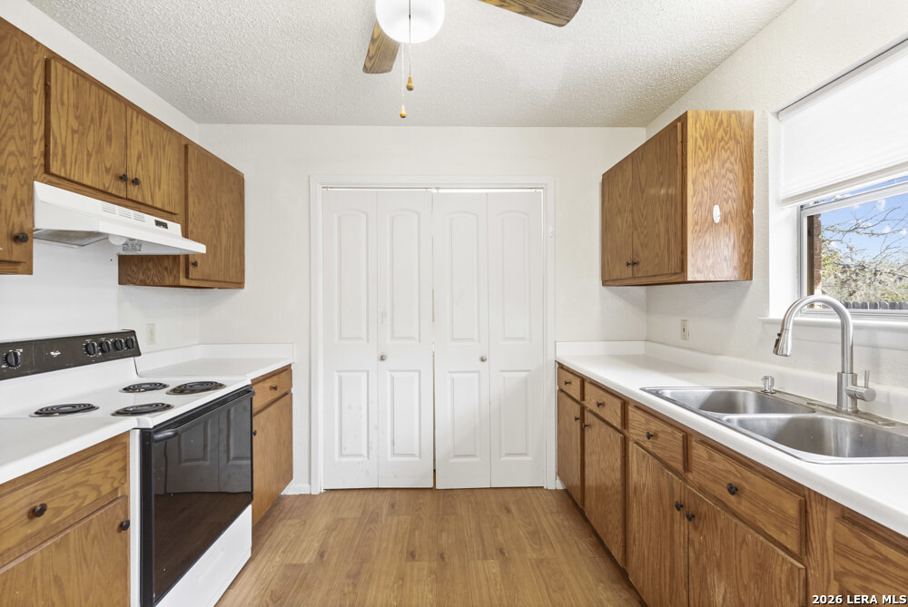 292 Montague Drive Bandera, TX 78003 - Photo 12 of 24 a kitchen with sink a stove and cabinets